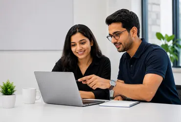 Expert SAP trainer guiding young student and professional on a training module on a laptop at Dimension Technologies